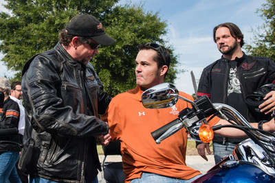 Bill Davidson, great-grandson of Harley-Davidson co-founder William A. Davidson, congratulates U.S. Air Force veteran Dorsey “Barney” Fyffe after delivering a 2015 Harley-Davidson motorcycle while Jason Cross, a U.S. Marine Corps veteran and retail supply planner at Harley-Davidson looks on. The surprise delivery jumpstarted a new partnership between Harley-Davidson and Wounded Warrior Project to help improve the lives of service men and women living with post-traumatic stress disorder (PTSD).