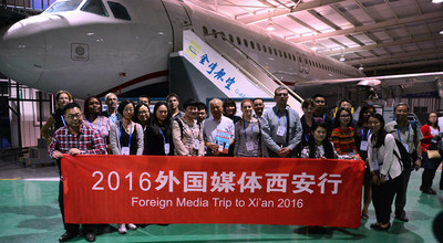Group photo of the journalists in G-aero, a maintenance and training company in Weibei Industrial Zone, where parts of China\'s own jet airliner C919 are made.