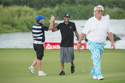 Basketball Hall of Famer Allen Iverson high-fives Liverpool football legend Robbie Fowler during their round with golfing champion John Daly at 2016 Mission Hills World Celebrity Pro-Am in China.