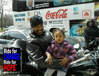 WORLD OF SOUL MOTORCYCLE COMMUNITY RIDE FOR CHANGE Moments before the 2nd Annual Ride for CHANGE-Ride for HOPE Motorcycle Motorcade Escort supporting the PUSH Excel HBCU Tour, Greg, a Chicago area biker poses for a photograph with 3 year old Myia McLemore who penned her own slogan "Stop the Violence-Save My Friend." (PRNewsFoto/World of Soul Motorcycle Community) CHICAGO, IL UNITED STATES 