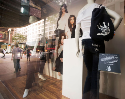 Sears revealed a window display at its State Street store Monday, August 5, 2013 in Chicago, showcasing three pairs of jeans decorated by Kim, Khloe and Kourtney Kardashian to raise awareness of Team Up to Stop Bullying. The decorated jeans – featuring the autograph and handprint of each celebrity sister to symbolize her commitment to end bullying – will be awarded to winners of a Shop Your Way Rewards sweepstakes, with Sears making a donation to the non-profit charities associated with Team Up to Stop Bullying for every entry. (John Konstantaras / AP Images for Sears).