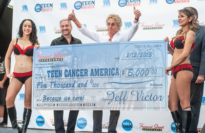 Roger Daltrey, lead singer of The Who accepting a check from Fremont Street Experience President Jeff Victor for Teen Cancer America a charity inspired by Daltrey and Pete Townshend Monday, Aug. 12 at Fremont Street Experience in Downtown Las Vegas.