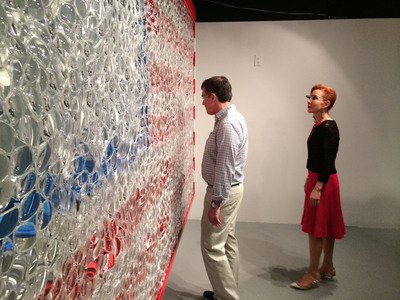 Patrick Moore, Deputy Director of The Andy Warhol Museum, and Michele Fabrizi, chair of The Warhol's Board of Directors, interacting with David Datuna's Portrait of America.