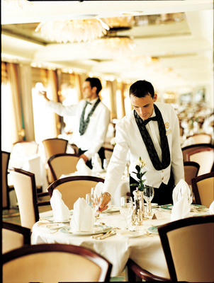 Waiters prepare tables for dining in the Crystal Dining Room.