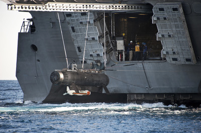 US Navy photo:  The Remote Minehunting System (RMS) and an AN/AQS-20 minehunting sonar (attached underneath) are brought aboard the littoral combat ship USS Independence (LCS 2).