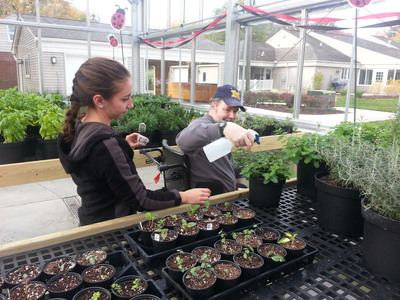 Greenhouse Coordinator Linda Davis helps client Brian O. Know which plants need water.