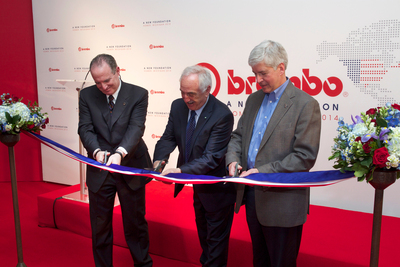 Alberto Bombassei, chairman of Brembo S.p.A., Daniel Sandberg, president and CEO of Brembo North America, and Michigan Governor Rick Snyder cut the ceremonial ribbon to mark the grand opening of Brembo's expanded manufacturing operations in Homer, Michigan.