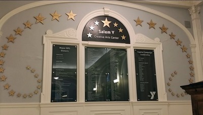 The glass donor wall by Impact Architectural Signs for the Salem YMCA.