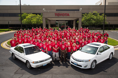 The first Toyota vehicle and the 10 millionth pose with group of team members.