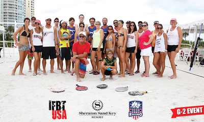 (Center) Steve Culver, Beach Tennis Pro and the Activities Coordinator for Sheraton Sand Key Resort with Competitors from around the world at the 2014 Sand Key Beach Tennis Open.