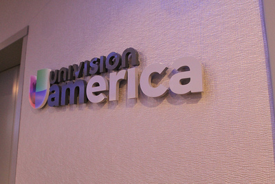 The Univision America sign consists of colored letters that pop from the wall and is overall friendly and approachable.