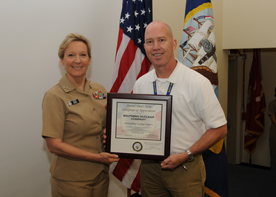 Jeff Gasser, Executive Vice President of Operational Readiness and Site Integration for Vogtle 3 and 4, accepts an award on behalf of Southern Nuclear from Vice Admiral Robin Braun, Chief of Navy Reserve. The award recognizes SNC as an outstanding employer in support of its Reserve sailors.