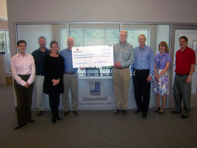 Gregory Cockerham, Community Bank of the Chesapeake Chief Lending Officer, joined by members of the Bank team, present Woody Van Valkenburgh, Goodwill President / CEO, and members of the Goodwill team, the donation check.