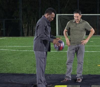 Pele demonstrates revolutionary shin guard technology at the World Cup host city
