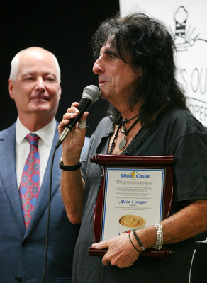 Alice Cooper is inducted into the White Castle Cravers Hall of Fame at the home office in Columbus, Ohio. Bill Ingram, CEO of White Castle, looks on as Cooper thanks a room full of White Castle team members for this honor. Picture courtesy of -- Laura Sifferlin Photography