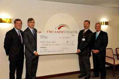 From left to right, David Fuller, president and CEO of SunTrust's Central Florida Division, and Bill Rogers, chairman and CEO of SunTrust Banks, Inc., present a $250,000 gift to Orlando Health's interim president and CEO, Jamal Hakim, MD, and senior vice president, John Bozard, to help support Orlando Regional Medical Center's redesign and renovation project.