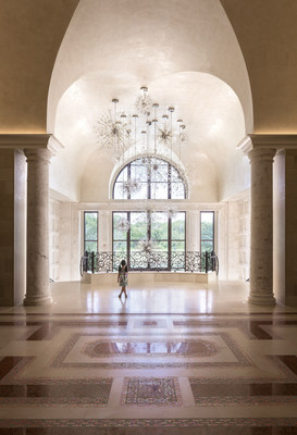 The custom firework-inspired crystal chandelier in the grand entryway evokes a sense of wonder.