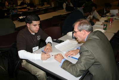 Aponte works on homework in 2010 with Stand & Deliver mentor Steve Horlitz.
