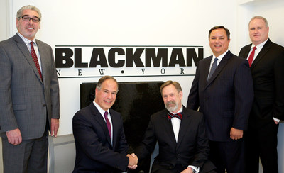 (Center R-L) David Krakoff and Robert Mannheimer seal the companies' new distribution deal with a handshake. They are flanked (L-R) by David Lyon, Director of Showrooms, Blackman Plumbing Supply; Jason Fitzsimmons, Vice President, United States Sales Division, TOTO USA; and Kevin Burns, Regional Director, Northeast Region, United States Sales Division, TOTO USA.