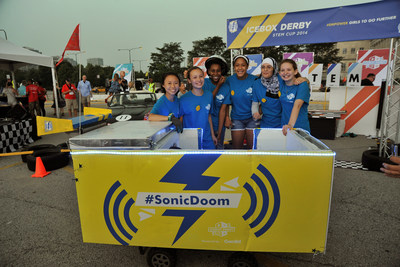 Members of team Sonic Doom - the winners of the first ever Icebox Derby STEM Cup - stand behind their race car, poised for action. This electric vehicle, built from a recycled refrigerator, was put to the test on Saturday, August 23, in a relay against five other teams and their Icebox Derby cars.