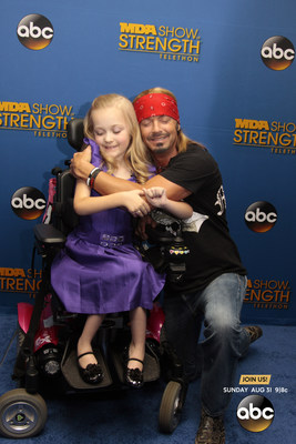 Rock legend Bret Michaels took his support behind-the-scenes at the 2014 MDA Show of Strength Telethon, airing tonight on ABC stations nationwide, to meet with families served by the Muscular Dystrophy Association. Michaels pledged a $10,000 donation to MDA’s National Goodwill Ambassador, 9-year old Reagan Imhoff on the blue carpet to help support MDA’s mission to save and improve lives of children and adults affected by muscle disease.