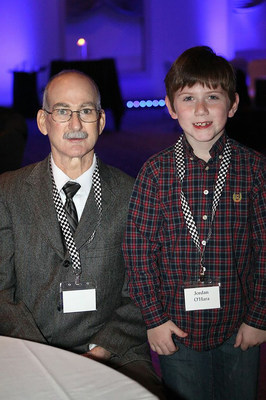Patrick O'Hara, wearing his Freedom portable driver that powered his SynCardia Total Artificial Heart, and his youngest son, Jordan, attend a Methodist Health Foundation banquet. O'Hara, the first Indianan to receive the SynCardia Heart, was a guest of honor.