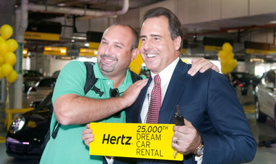 Mark Frissora, Hertz Chairman & CEO, right, celebrates 25,000th Dream Cars rental with customer Mike Yonover on Wednesday, Sept. 3, 2014 in Miami. (Mitchell Zachs/AP Images for Hertz)