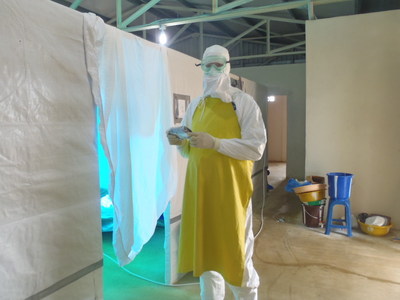 Deal protected by double-layered suit as he monitors an activated TRU-D in an Ebola Treatment Unit.