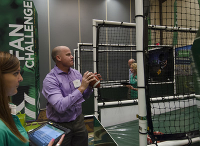 A fan participates in the 'Associated Packers Fan Experience' interactive zone that tests skills, accuracy, speed and smarts.