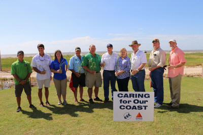 Community leaders join employees from the CITGO Lake Charles Refinery and the Coalition to Restore Coastal Louisiana in a ceremonial presentation of the dune grass planted along Holly Beach.