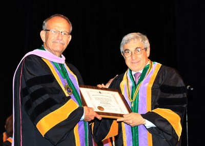 Stanley M. Bergman, Chairman of the Board and Chief Executive Officer, Henry Schein, Inc., is presented with Honorary Fellowship in the International College of Dentistry (ICD) - USA Section by Curtis R. Johnson, D.D.S., F.I.C.D., 2014 President.