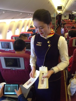 Hainan Airlines flight attendants distributing Change for Good donation bags to passengers 