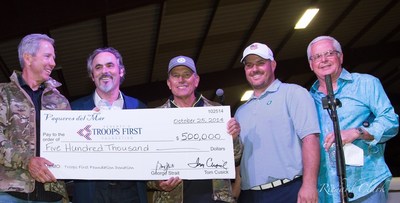Tom Cusick, David Feherty, of Feherty's Troops First Foundation, George Strait, golfer Chad Pfeifer (who lost his left leg above the knee serving in Iraq) and auctioneer Kerry Fisher celebrate record $550,000 raised at this year's Vaqueros del Mar Invitational Golf Tournament and Auction. The event benefits Feherty's Troops First Foundation. The foundation provides meaningful assistance to military members who have been wounded serving in Iraq or Afghanistan.