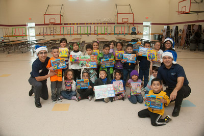 Thigpen-Zavala Elementary School students in McAllen, Texas pose with new toys received courtesy of the BBVA Compass Foundation's Project Blue Elf initiative.
