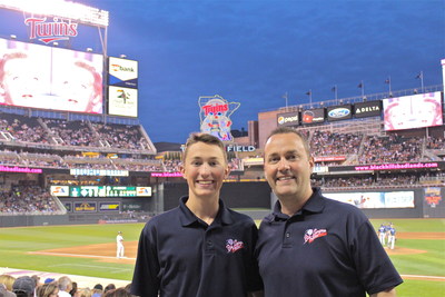 Glenn Dunlap and son, Hiatt share a moment together at Target Field celebrating their 30th baseball stadium.