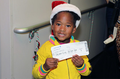A lucky little flyer shows off her boarding pass to see Santa at the North Pole at Houston Bush International Airport on Dec. 6, 2014.