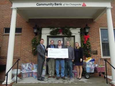 Community Bank of the Chesapeake representatives present a donation to the Southern Maryland Food Bank.