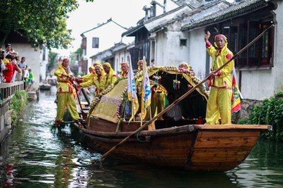 Dragon boat rowers on the waterways in Zhouzhuang; Dragon Boat rowing is an ancient ritual and a vital piece of Chinese heritage that Zhouzhuang is seeking to preserve