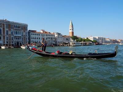 Wu Juan, a sampan rower from Zhouzhuang in China, joins a local Venetian gondolier in song.