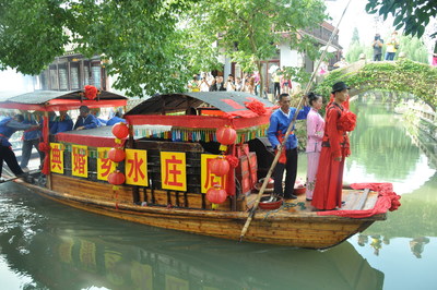 Zhouzhuang water town weddings begin with the groom escorting the bride by rowing a fast boat to the dock 
