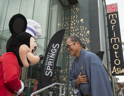 Mickey Mouse and Chef Masaharu Morimoto bow in celebration of the opening of Morimoto Asia Sept. 29, 2015 at the newly named Disney Springs complex at Walt Disney World Resort in Lake Buena Vista, Fla. Re-imagined from Downtown Disney, Disney Springs is doubling the number of shopping, dining and entertainment experiences opening in phases through 2016. (David Roark, photographer).