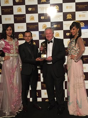 WTA Founder and President Graham Cooke hands over the trophy for the Worlds Leading Integrated Tourism Group