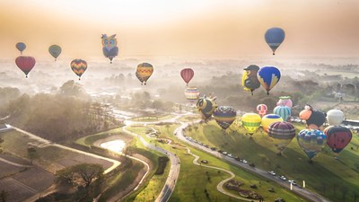 Balloons ascending into the sky over Singha Park’s rolling hills and plantations. Photo by: Phudinan Singkhamfu