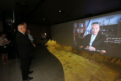 Israeli President Reuven Rivlin – joined by Dr. Evans, Museum Founder, and Gen. Peled, raised by Christians during the Holocaust – watching an introductory video by his predecessor, Shimon Peres, International Chairman of the Friends of Zion Museum. Photo Credit: Yossi Zamir