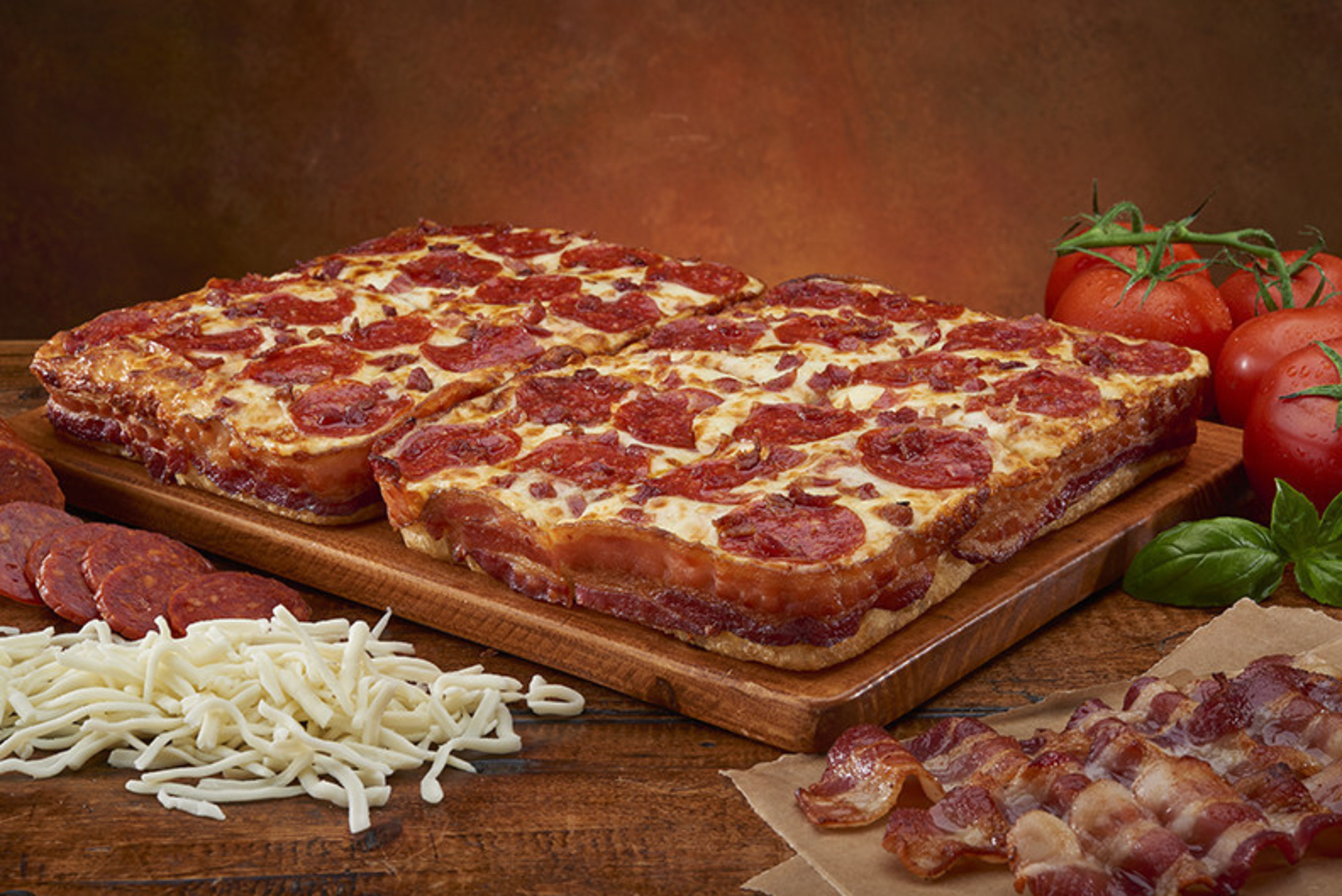 Beginning February 23, for a limited time, Little Caesars is offering a Bacon Wrapped Crust DEEP!DEEP! Dish pizza. Dive in to this 8-corner deep dish pizza wrapped in decadent whole strips of thick-cut, crispy bacon, and then topped with pepperoni and even more delicious bits of savory bacon goodness.