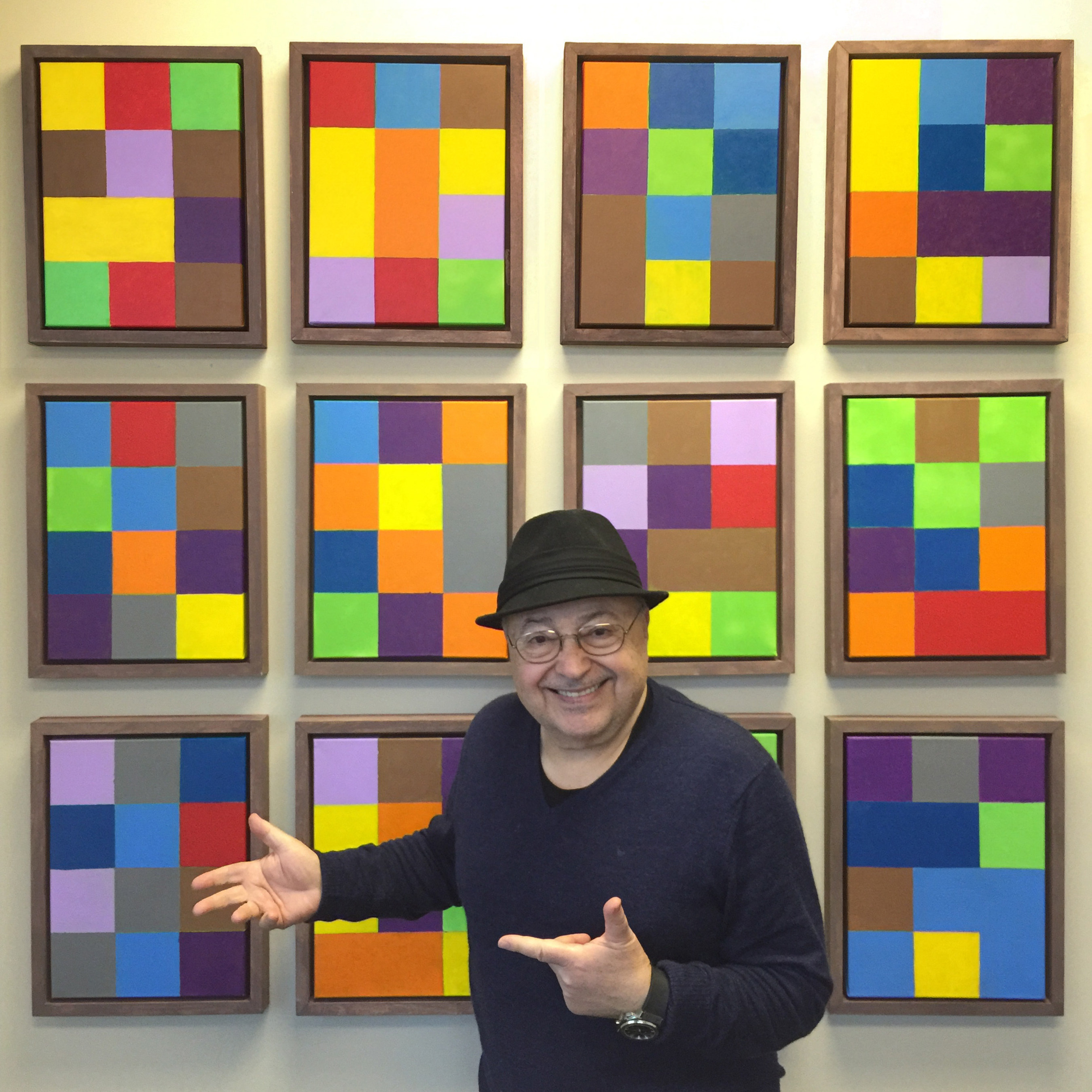 Artist Cano Ozgener in front of his Pi Synesthesia work called "Pi by the Dozen"