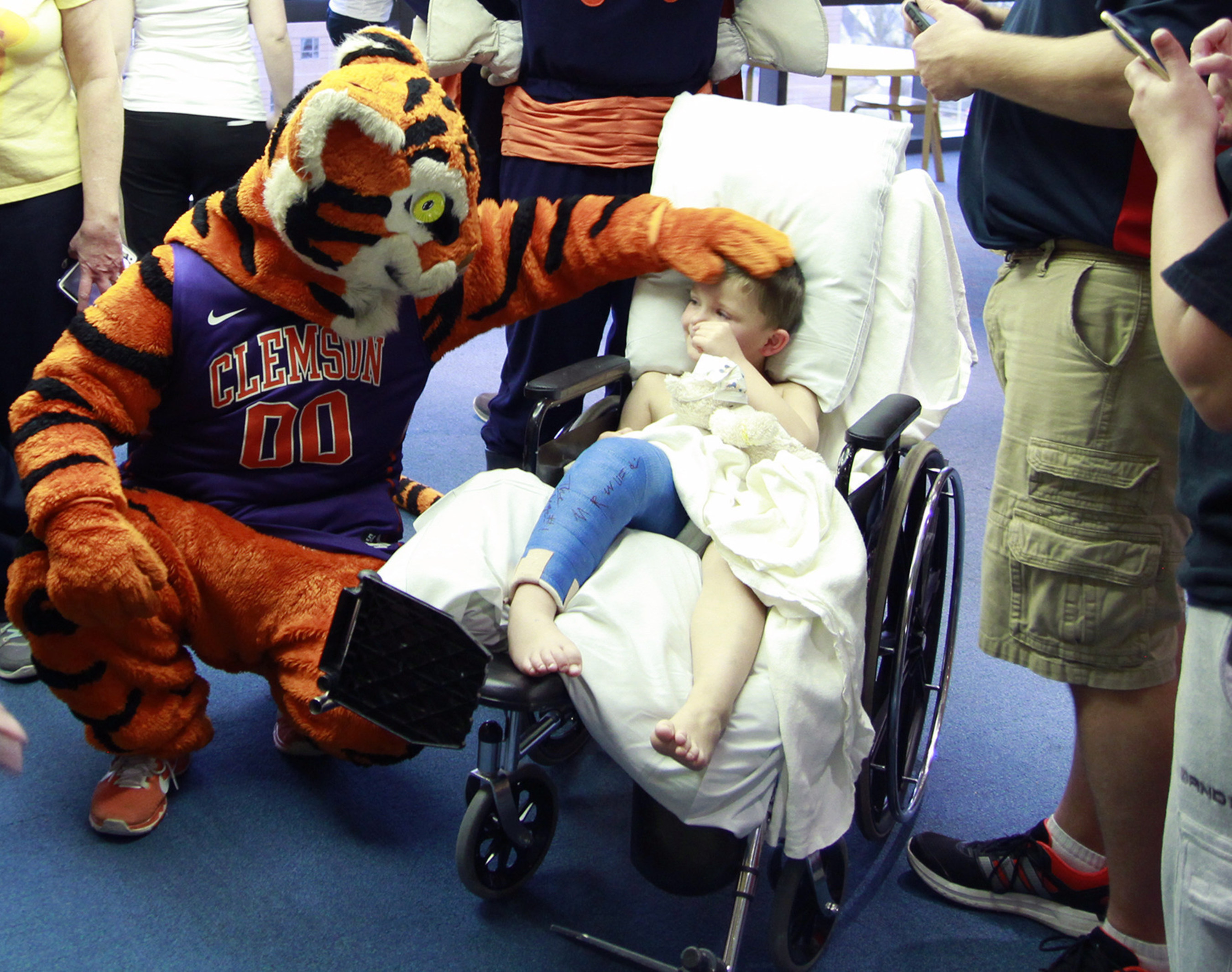Four-year-old Kyler Rippey smiles as the Clemson Tiger wishes him well. The mascots of the Atlantic Coast Conference paid a visit to Brenner Children's Hospital as part of an outreach initiative for the 2015 ACC Men's Basketball Tournament.