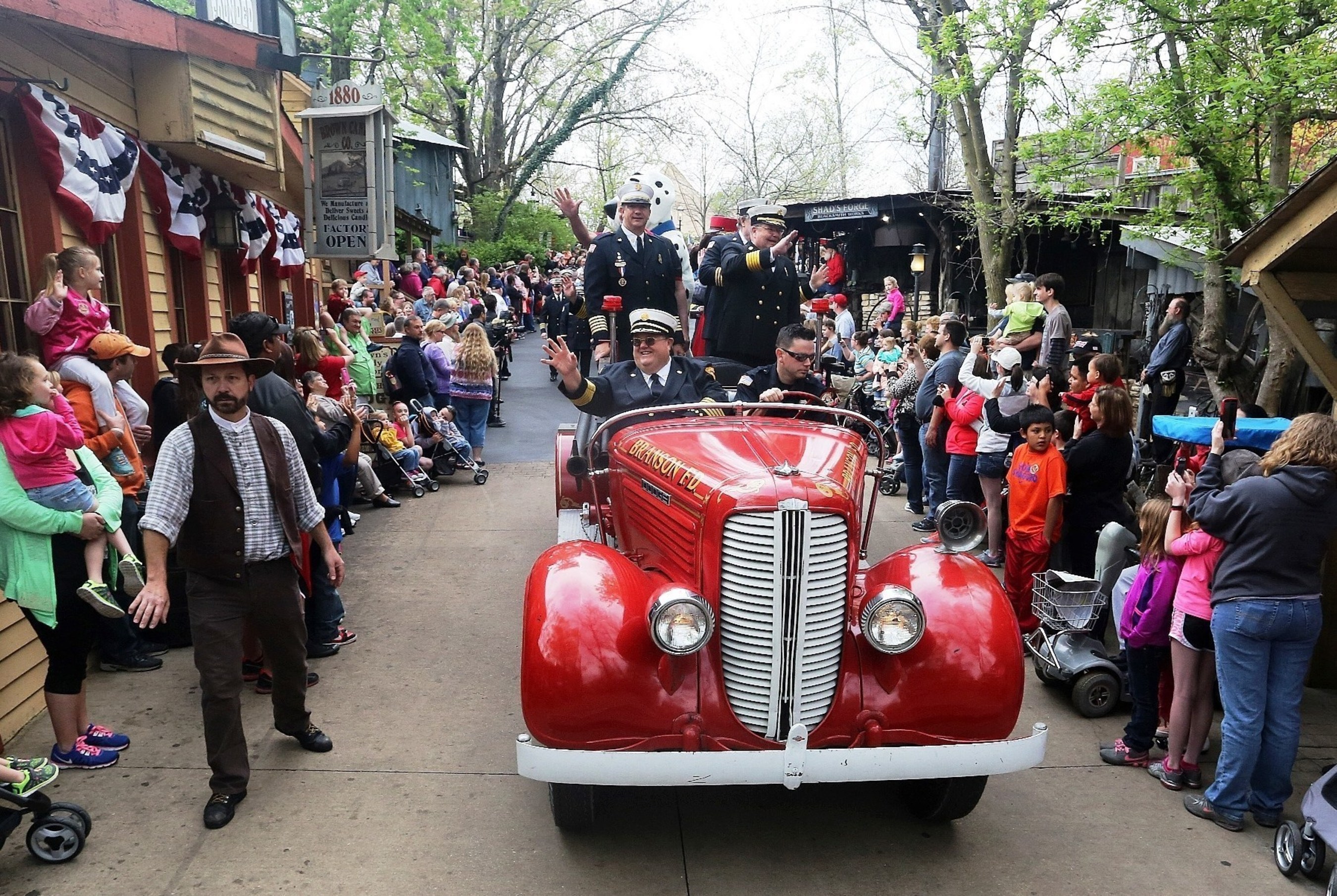 Uniformed firefighters led a parade through the streets of Silver Dollar City to Fireman's Landing, the theme park's new area with 10 family adventures, themed as a volunteer firefighter recruitment fair.