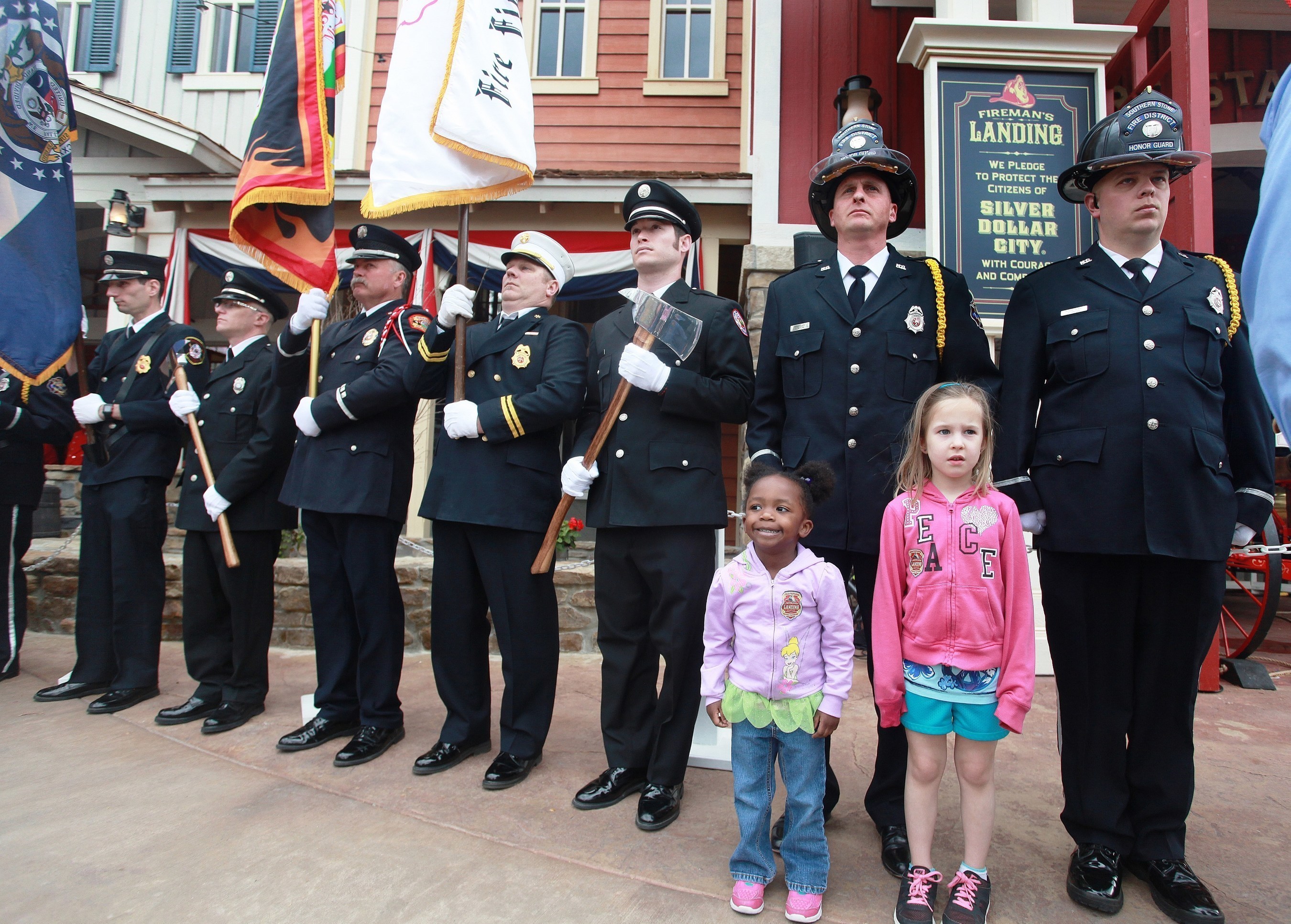 Kids join firefighters to take the Firefighter's Pledge at the grand opening of Fireman's Landing at Silver Dollar City in Branson, Missouri.