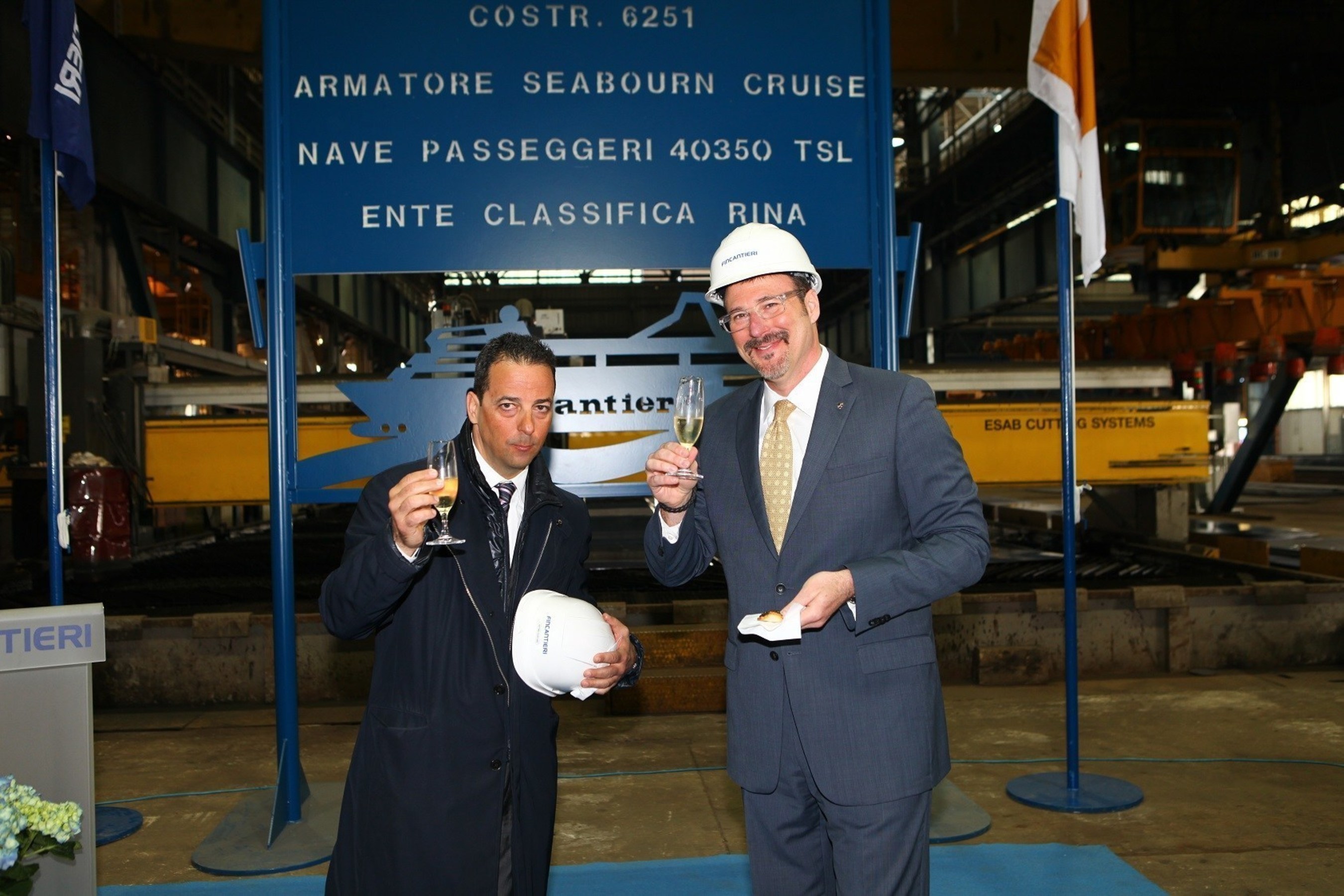 Antonio Quintano, Director of Fincantieri's Marghera shipyard, and Richard Meadows, Seabourn President, toast to the first steel cut for the line's newest ship, Seabourn Encore.
